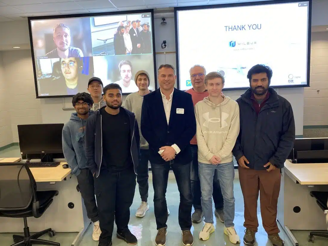 Jason Reed, president of the Digital Solutions Group and GATES Wilmington at GA Telesis LLC, stands with Penn State Brandywine students.