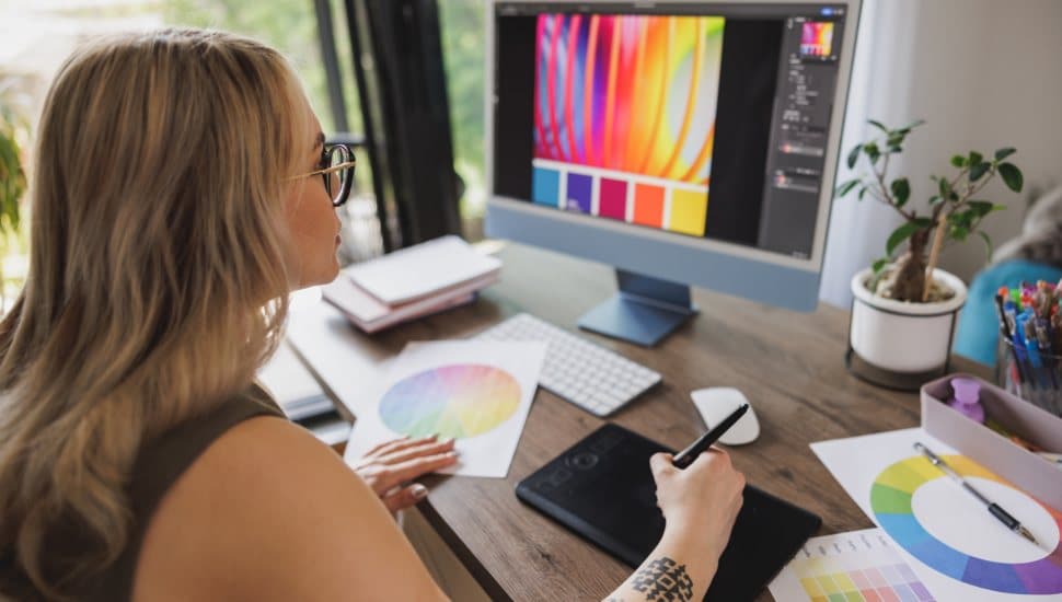 Creative young woman working on computer from her home office.