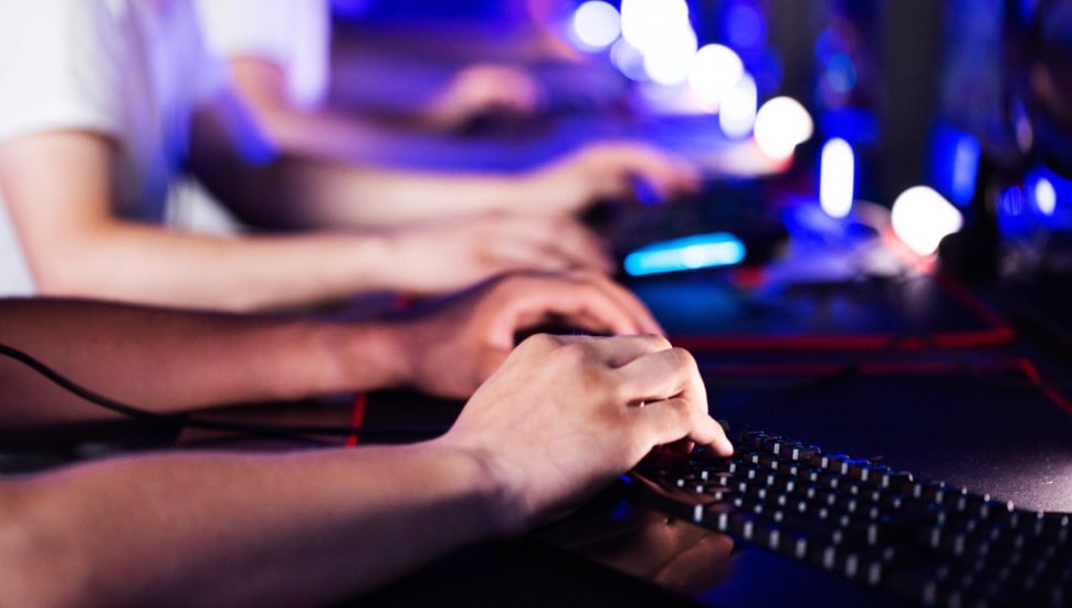 Students type on computer keyboards.