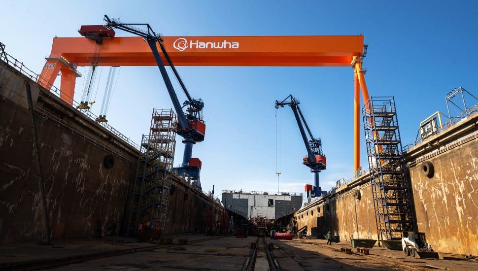 Massive gantry crane inside a dry dock at Hanwha Philly Shipyard in Philadelphia, highlighting modern U.S. shipbuilding infrastructure and workforce development.