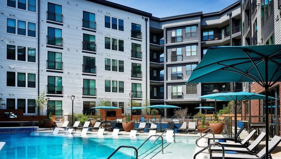 An apartment complex with a pool.