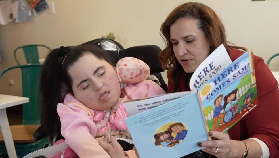 Phoenixville author and mom Jannesy DeLeon reads to a child.