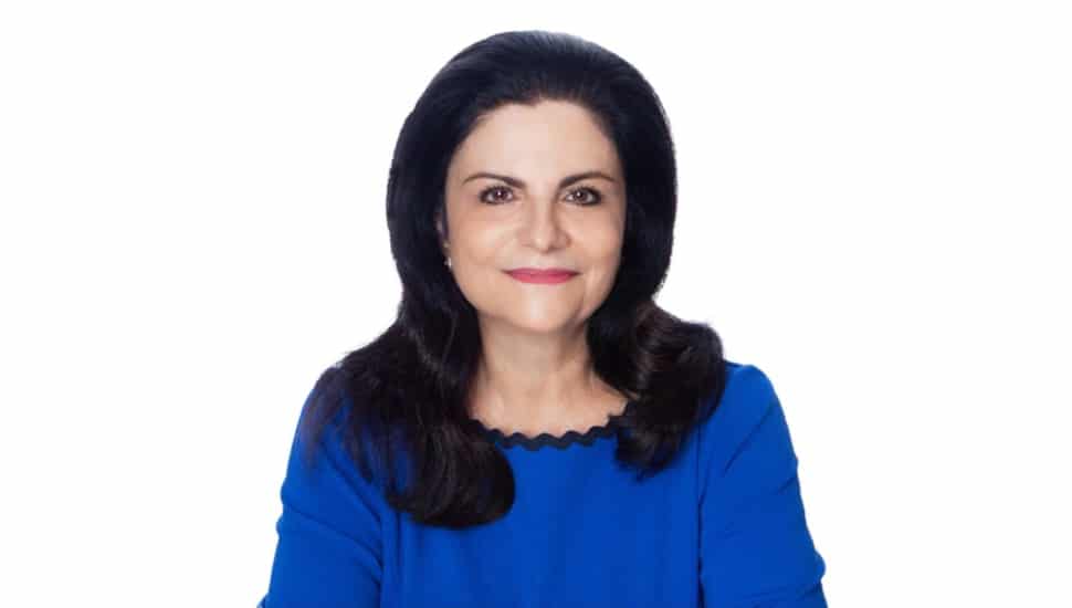 Headshot of middle-aged female executive in blue blouse.