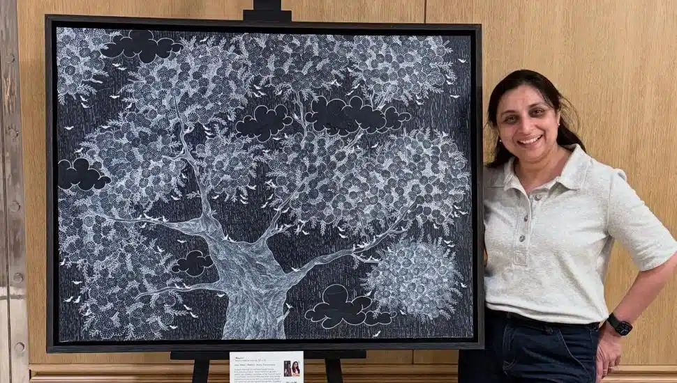 Rinal Parikh stands next to one of her works of art created for the 98th Rittenhouse Square Fine Art Show.