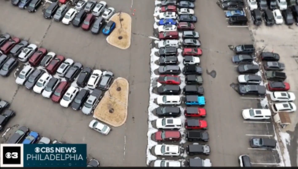 An aerial view of a car dealership lot with many cars parked.