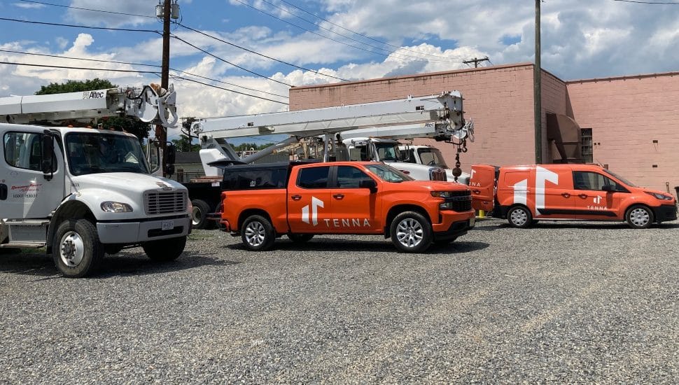 Tenna trucks parked in a lot.