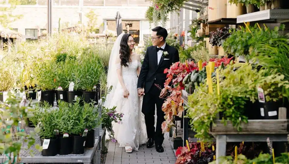 A couple is getting married in a garden setting at Terrain Events.