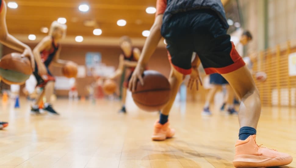 Young basketball players getting in some practice time on the court.