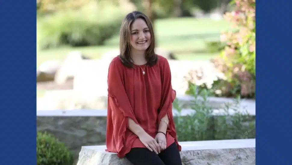 Danielle Guth, a Penn State Brandywine graduate, poses for a photo outside.