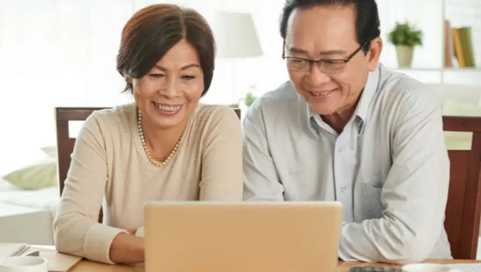 A couple looking at a laptop.
