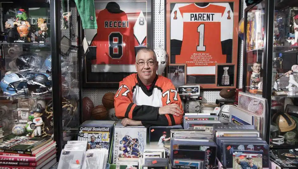 Carl Henderson, surrounded by his sports memorabilia at Carl's Cards & Collectibles in Havertown.