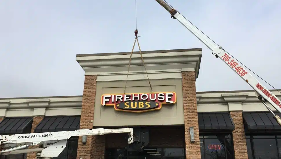 A Firehouse Subs sign erects over a new location.