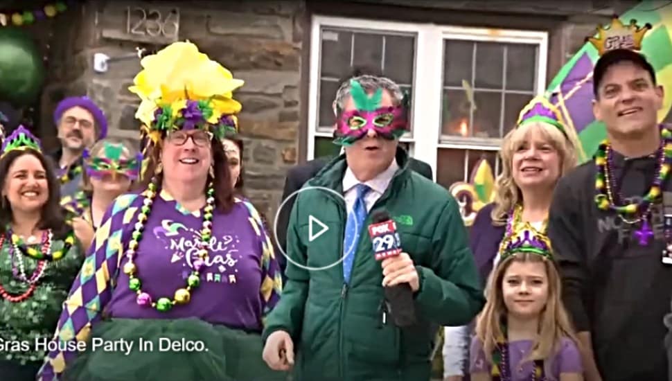 Paula, the hostess, guests and Bob Kelly from Fox 29 stand outside the Mardi Gras house in Drexel Hill, scene of an annual Mardi Gras party.