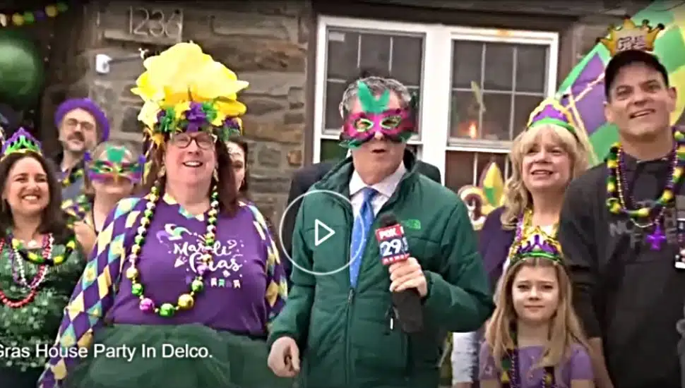 Paula, the hostess, guests and Bob Kelly from Fox 29 stand outside the Mardi Gras house in Drexel Hill, scene of an annual Mardi Gras party.