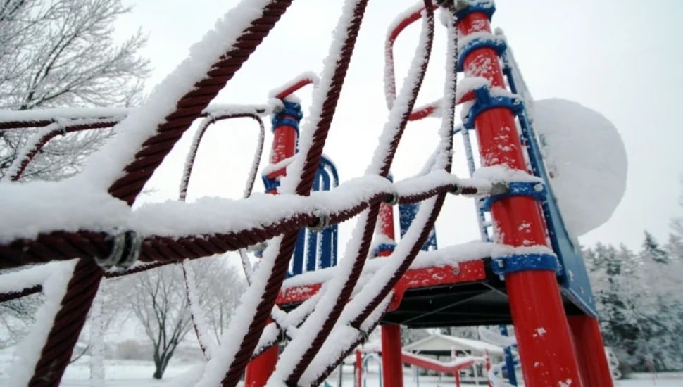 Snow-covered playground equipment.