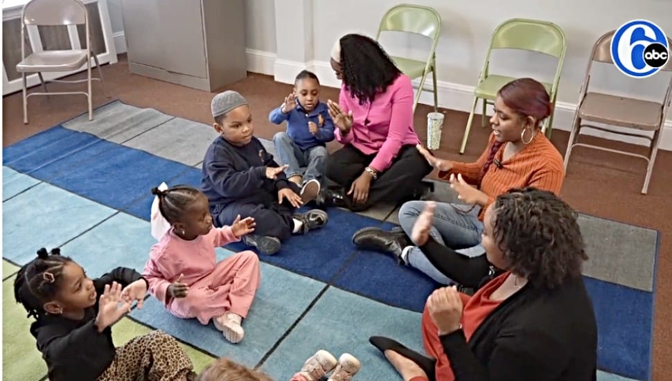 Teachers from Darlene’s Wee Care play with the children in a new daycare center while their facility is rebuilt.