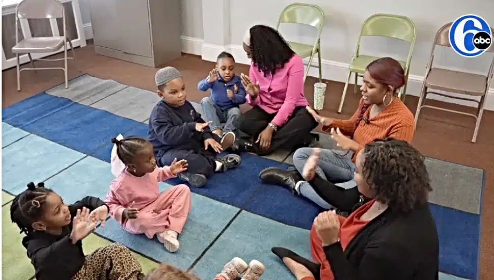 Teachers from Darlene’s Wee Care play with the children in a new daycare center while their facility is rebuilt.