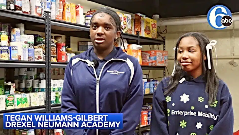 Tegan-Williams-Gilber and a fellow student talk about the food pantry at Drexel Neumann Academy in Chester.