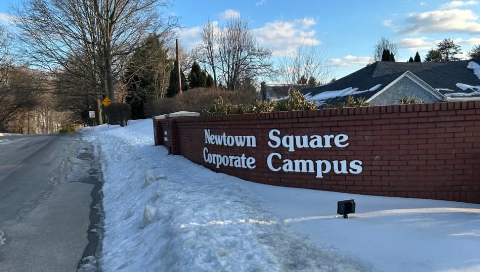 The sign for the Newtown Square Corporate Campus with snow on the ground.