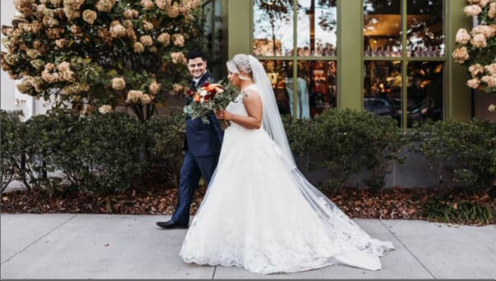 A Bride and Groom on an outside walkway at the Inn at Swarthmore.
