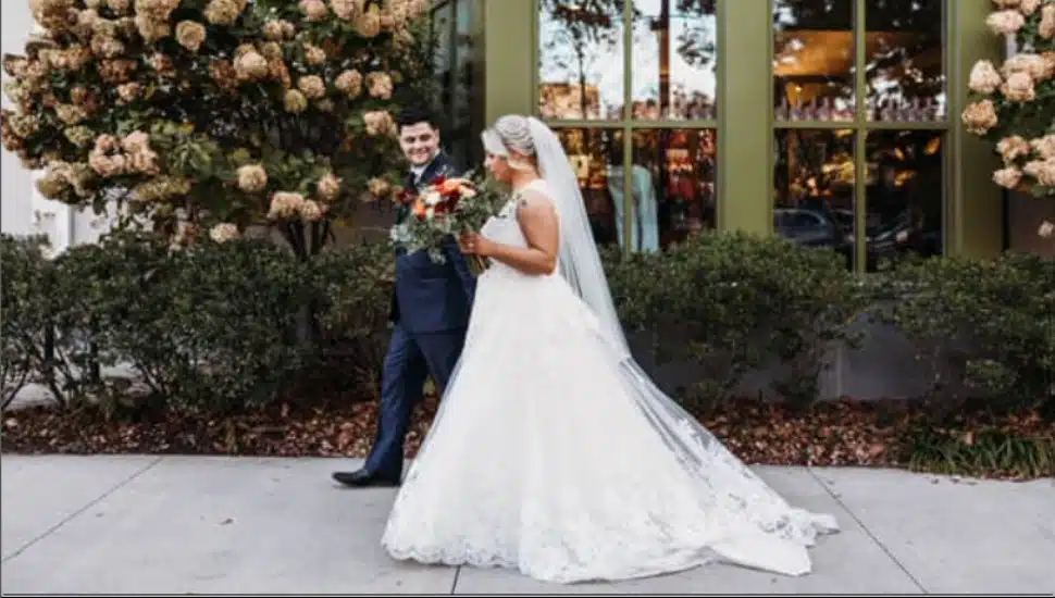 A Bride and Groom on an outside walkway at the Inn at Swarthmore.