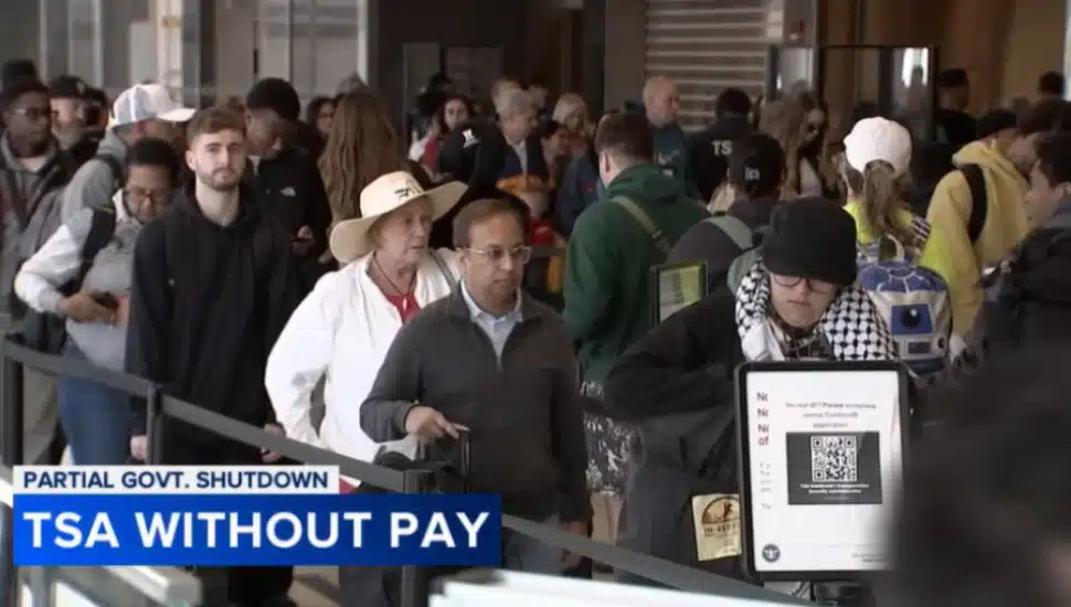 Passengers wait in line at a TSA security checkpoint at Philadelphia International Airport.
