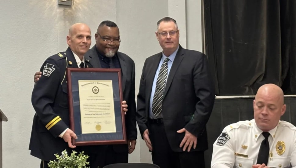Celebrating the Yeadon police department’s newly earned state accreditation are, (from left), borough Police Chief Henry Giammarco with the certification, Yeadon Mayor Rohan Hepkins and Nether Providence Police Chief David Splain, who represented the certifying agency, PLEAC.