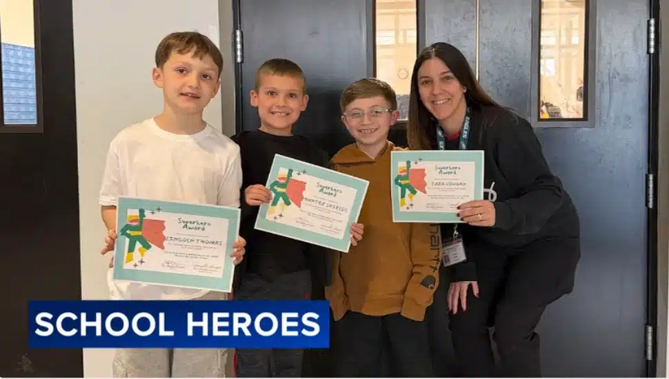 Damian Pascale stands with teacher Tara Vaughn and three of his classmate friends, who were honored with superhero awards for their efforts saving Damian who was choking.