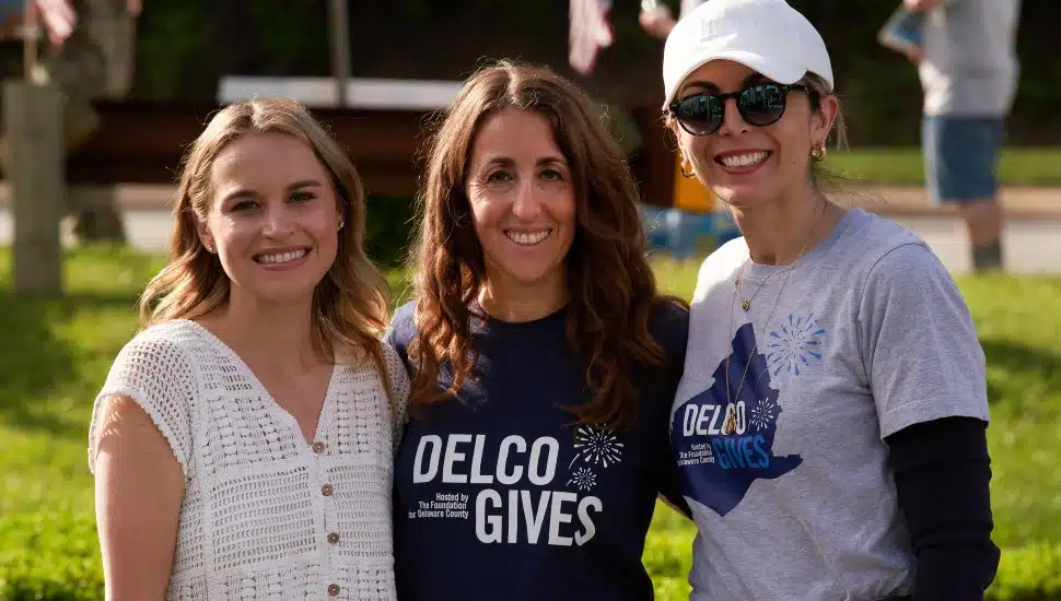 Three women show their support for Delco Gives at a 2025 tailgate celebrating the charity event.