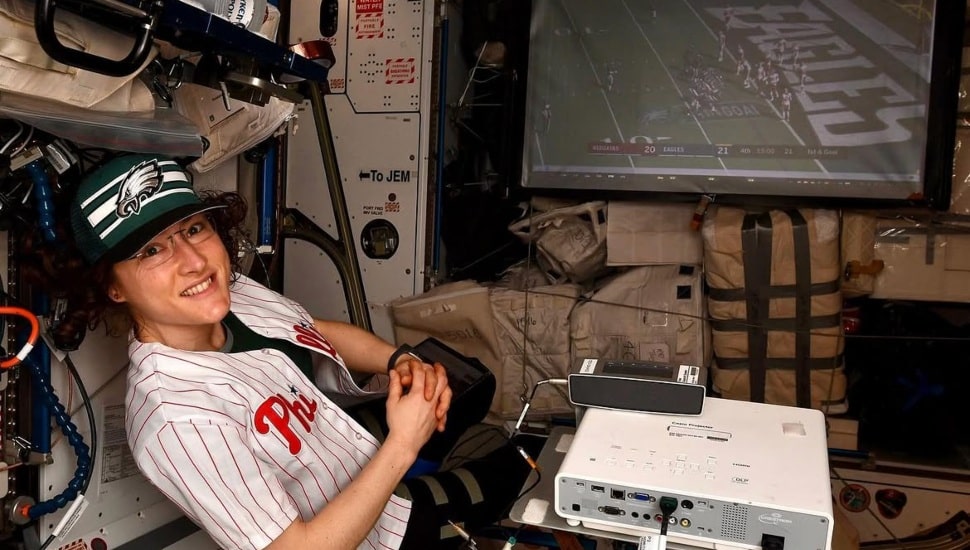 Christina Koch at International Space Station with an Eagles game in the background.