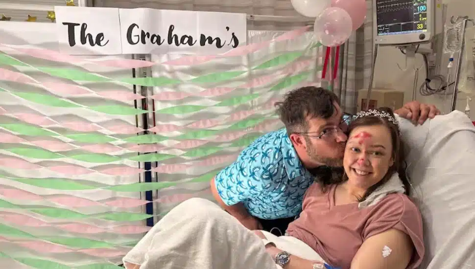 Derek Graham and Melissa Kellogg pose for a hospital bed wedding photo at Lankenau's emergency room.