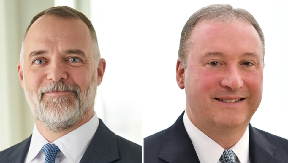 Headshots to two middle-aged male executives at utility company.