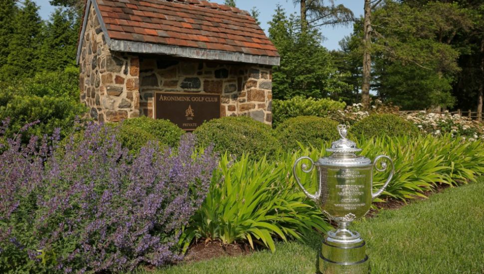 The Wanamaker trophy rests next to a landscaped sign at the Aronimink Golf Club in Newtown Square.