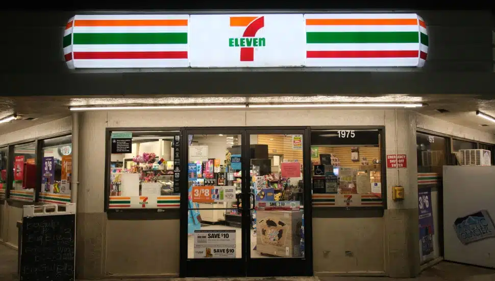 A 7-Eleven store front entrance at night.