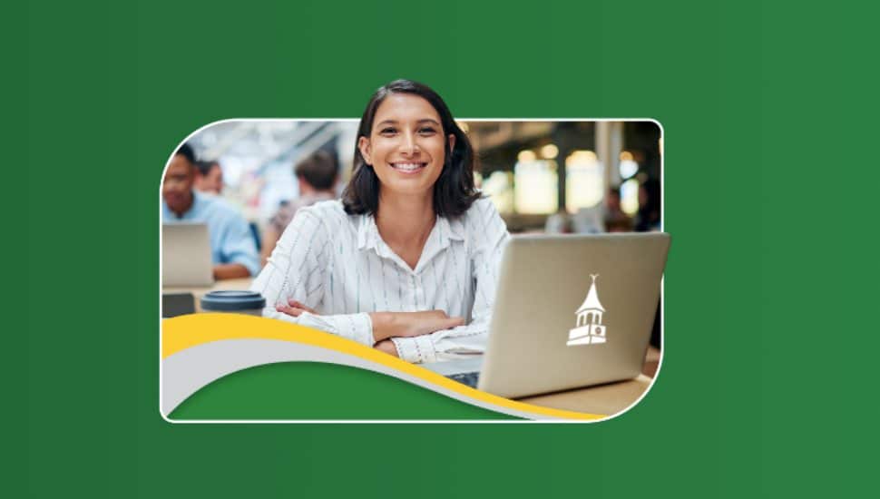 A smiling student sits with a laptop displaying Wilmington University branding during a promotional open house event.