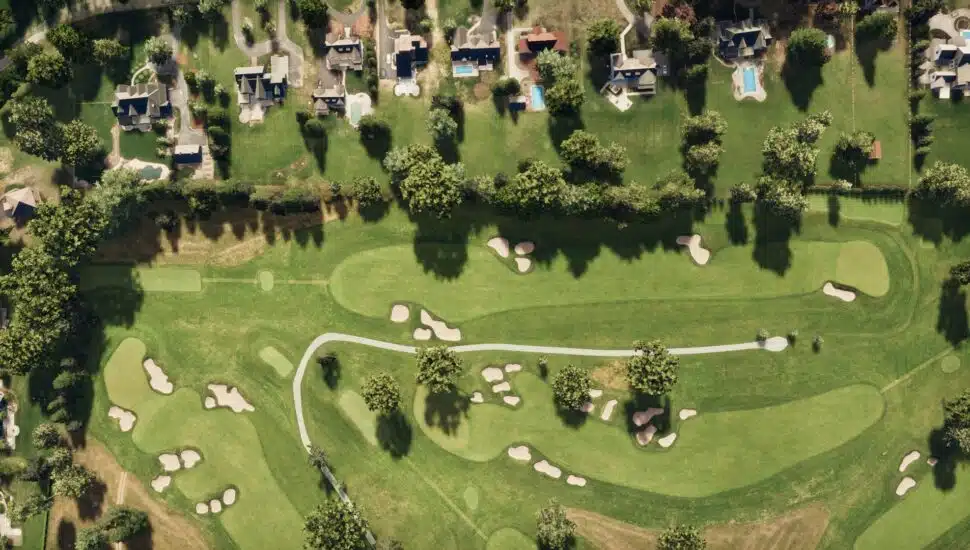 Aerial view of Hole 4 at Aronimink Golf Course next to some houses.