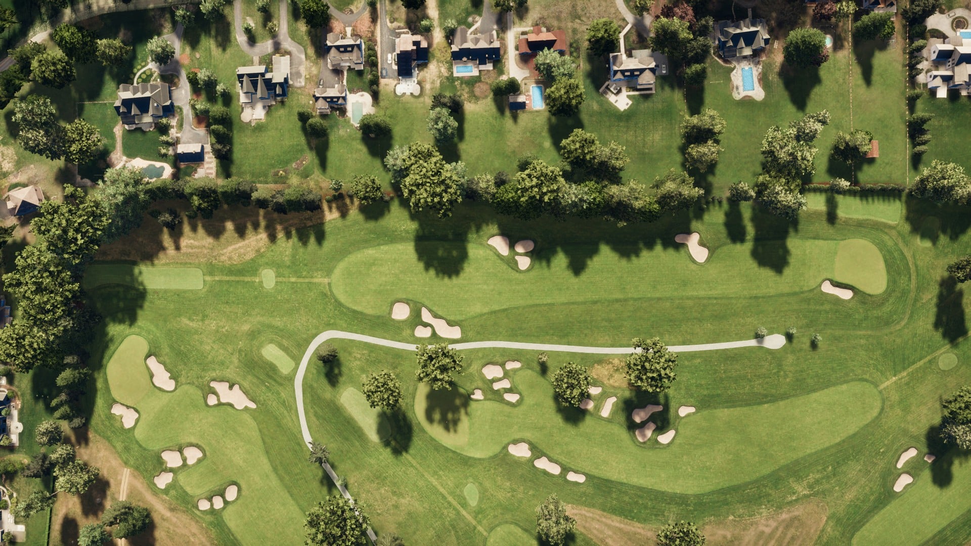 Aerial view of Hole 4 at Aronimink Golf Course next to some houses.
