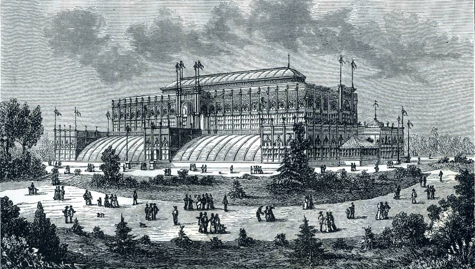 Black and white engraving of the Main Exhibition Building at the 1876 Philadelphia Centennial Exposition with crowds of visitors on the grounds.