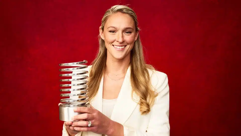 Kylie Kelce holding her Webby Award.