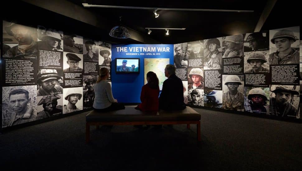 People sitting in the Pennsylvania Veterans Museum's Vietname War exhibit.