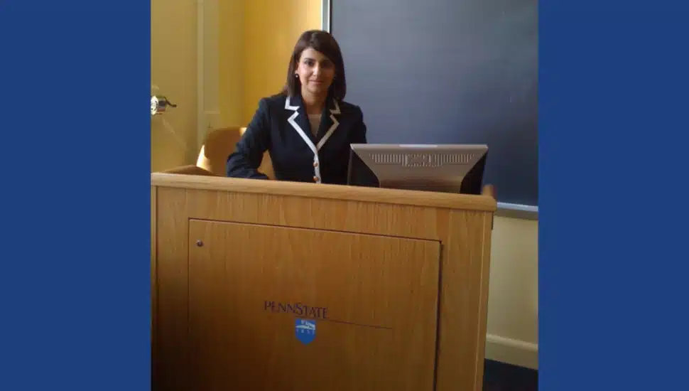 Lusine Mueller stands behind a Penn State podium.