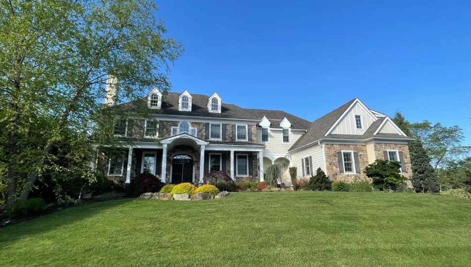 Stone, gables, and a wraparound front lawn at 1024 Brick House Farm Ln. in Newtown Square.
