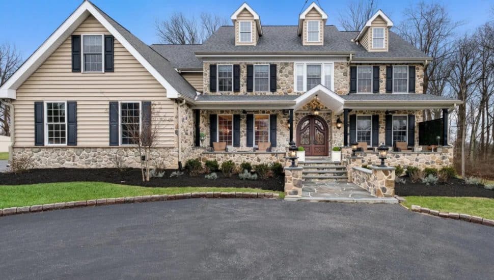 Large stone colonial with double doors.