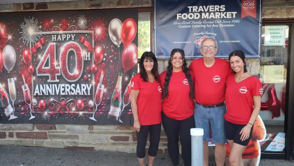 Dave and Donna Travers with their daughters out front of Travers Food Market.