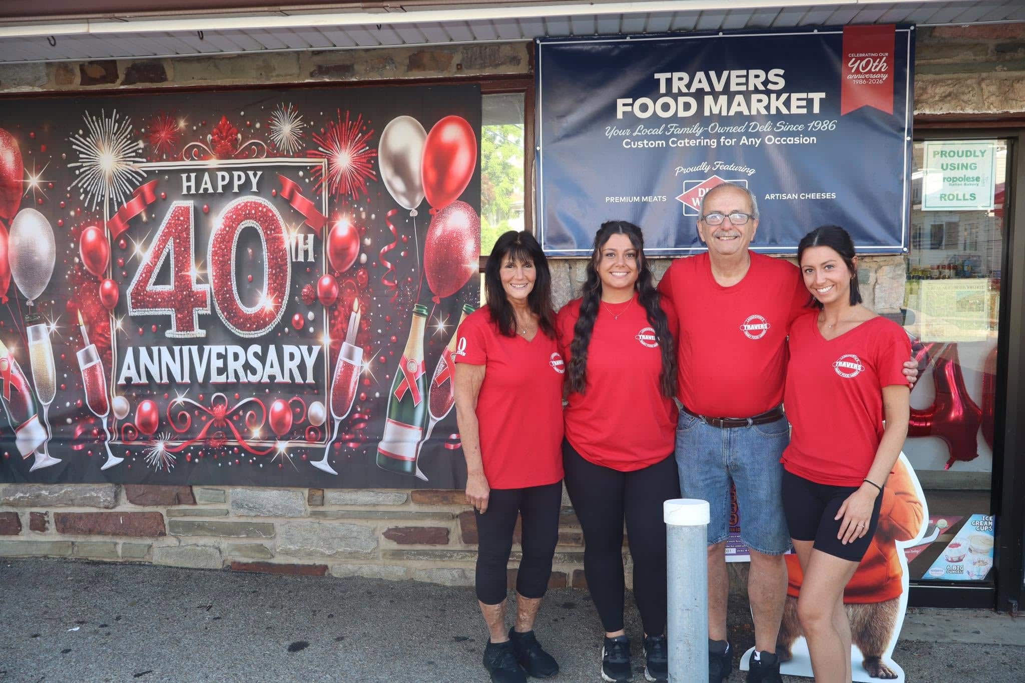 Dave and Donna Travers with their daughters out front of Travers Food Market.