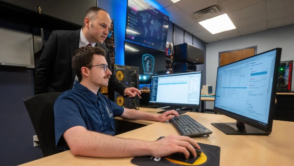 Lab director Joe Walsh superising intern Matt Revelas at the N.I.T.E. Center at Neumann University.