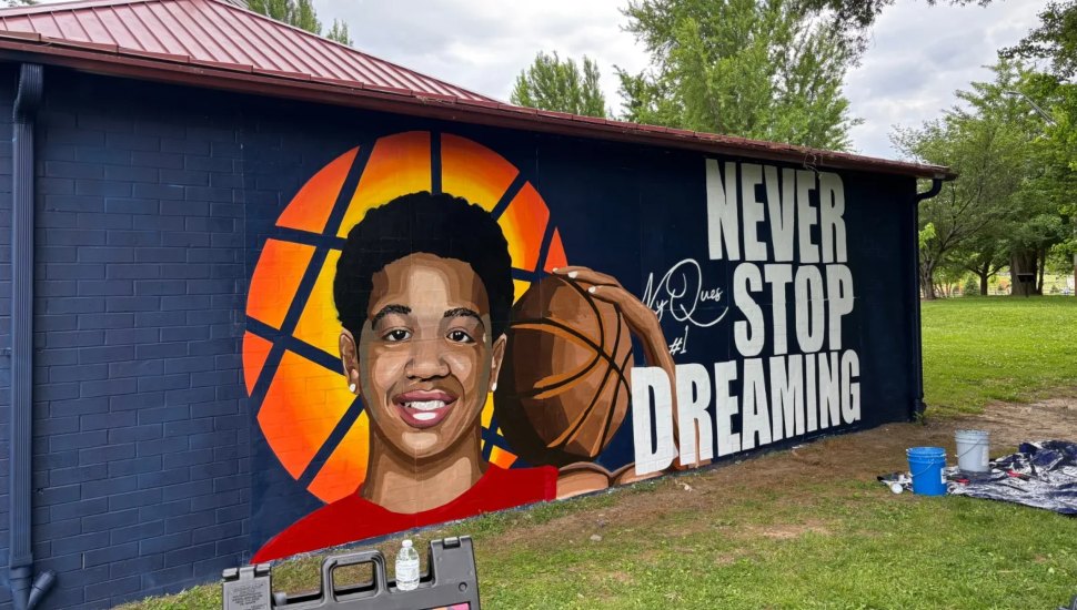 Mural of Ny'Ques Farlow-Davis holding a basketball at the Chester library.