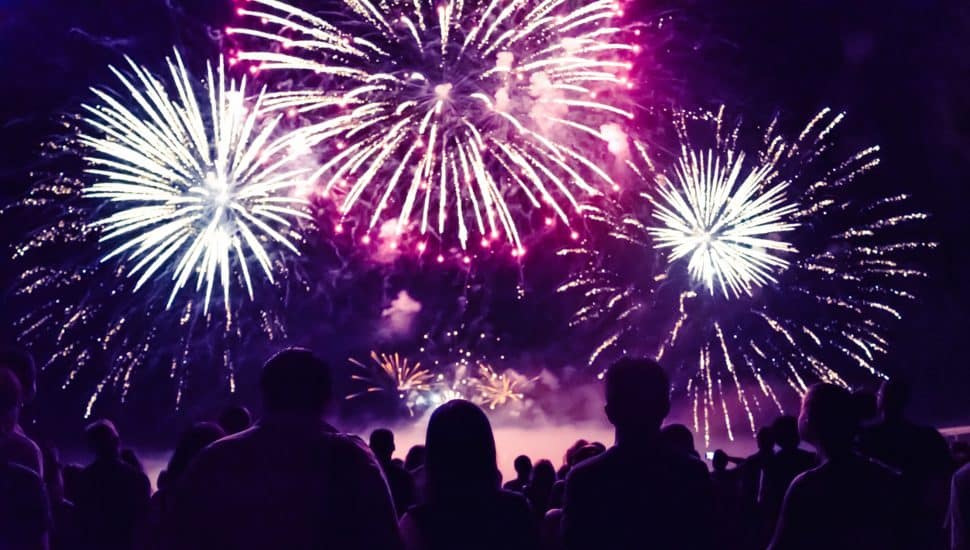 Crowd watching fireworks and celebrating new year.