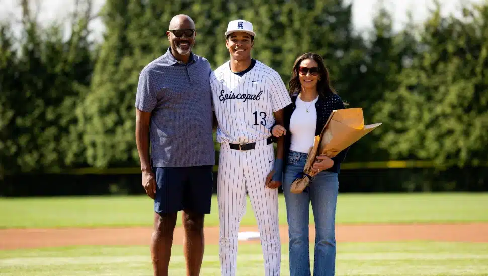 Reggie King with his parents on the Episcopal Academy field.
