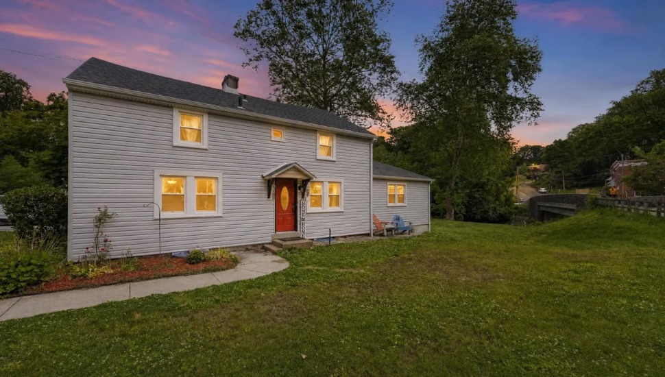 Warm light spills from the windows of this 19th-century Springfield farmhouse.